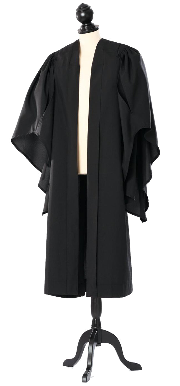 Cambridge bachelor's gown in black, open front and wide sleeves, on a tailor's mannequin