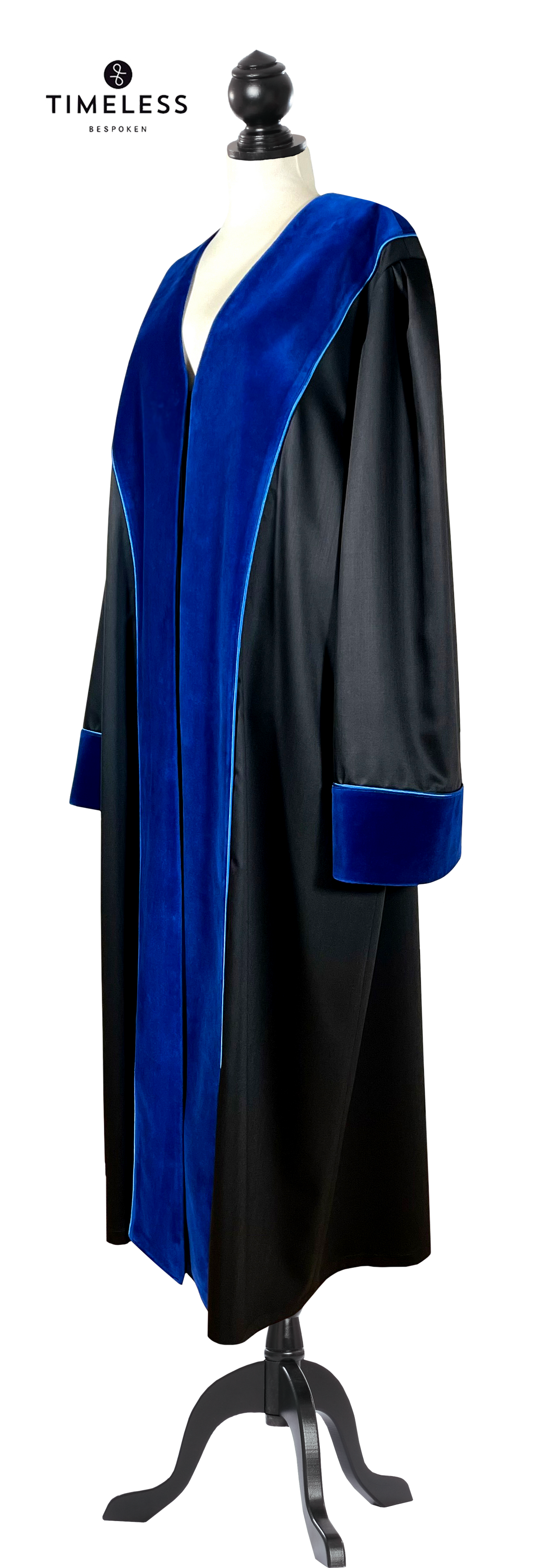 Black UPC First Instance judicial robe with blue velvet facings on lapels and cuffs, finished with blue piping, side view on a tailor dummy
