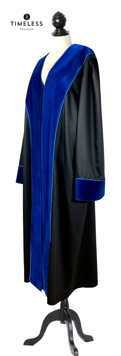Black UPC First Instance judicial robe with blue velvet facings on lapels and cuffs, finished with blue piping, side view on a tailor dummy