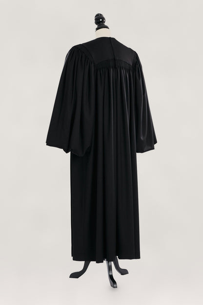 Magisterial US Judge Robe in black, back view, gathered yoke, full bloused sleeves, on a tailor mannequin