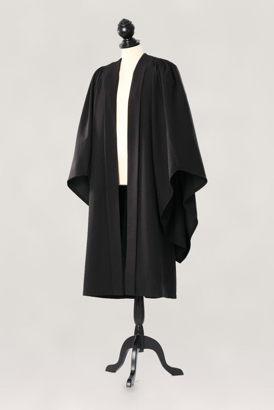 Oxford bachelor's gown in black, open front and broad sleeves, on a tailor's mannequin