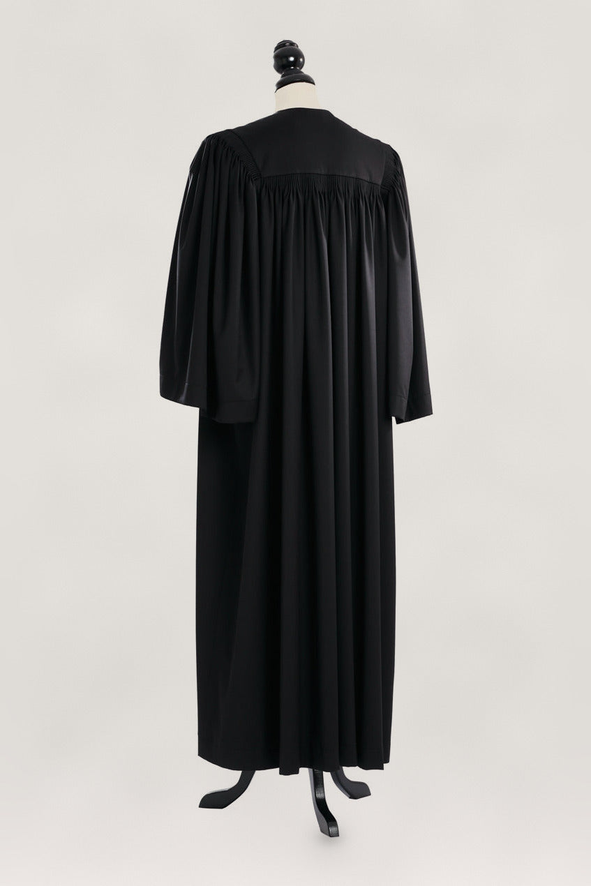 Principal US Judge Robe in black, back view, gathered yoke, medium half-bell sleeves, on a tailor mannequin