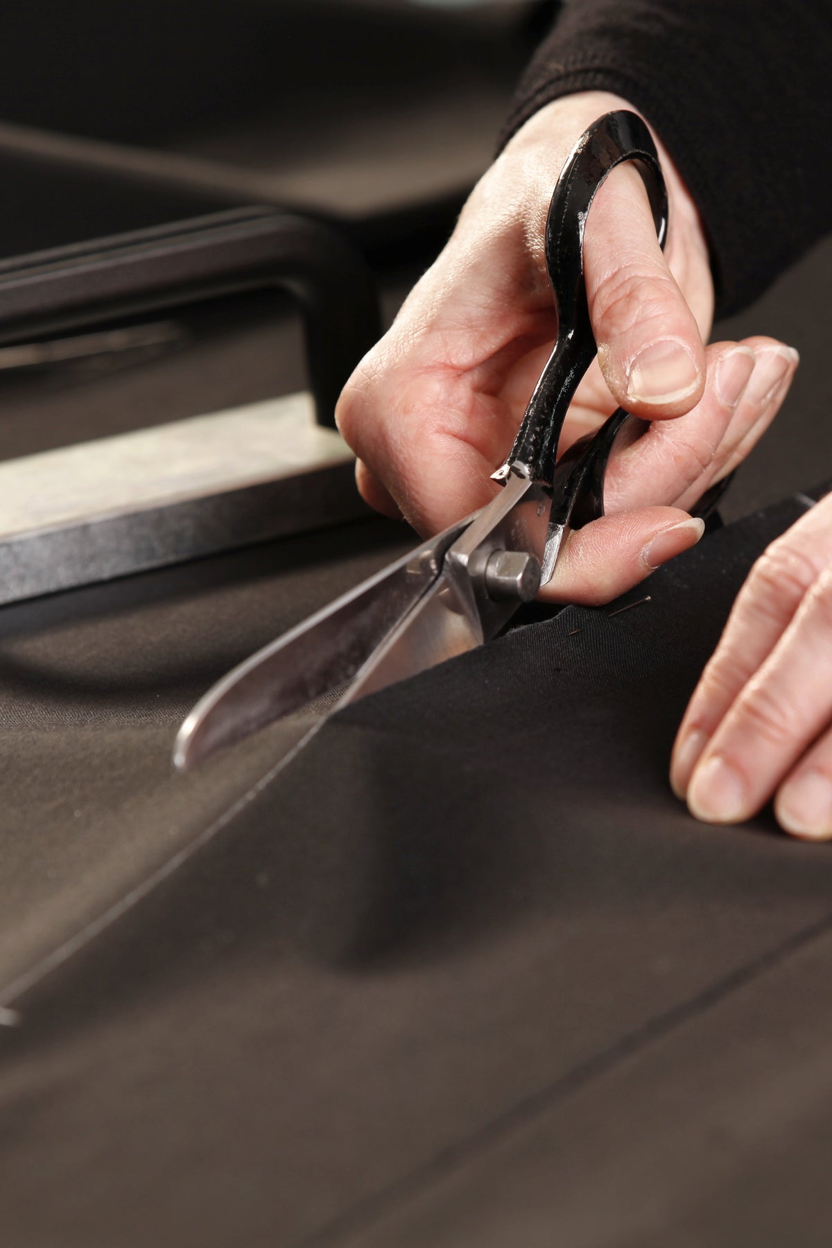 Handcrafted in our atelier: cutting the robe cloth by hand