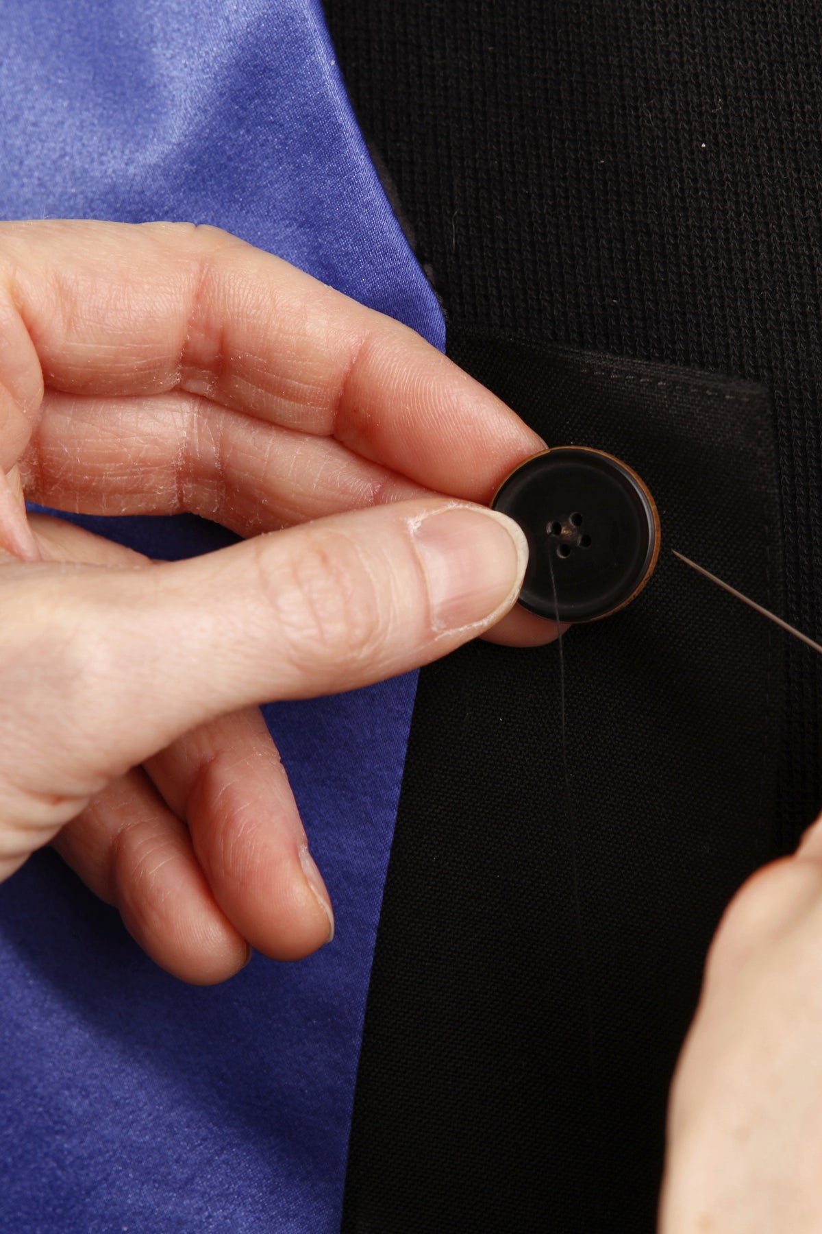 Handcrafted in our atelier: sewing on a button by hand