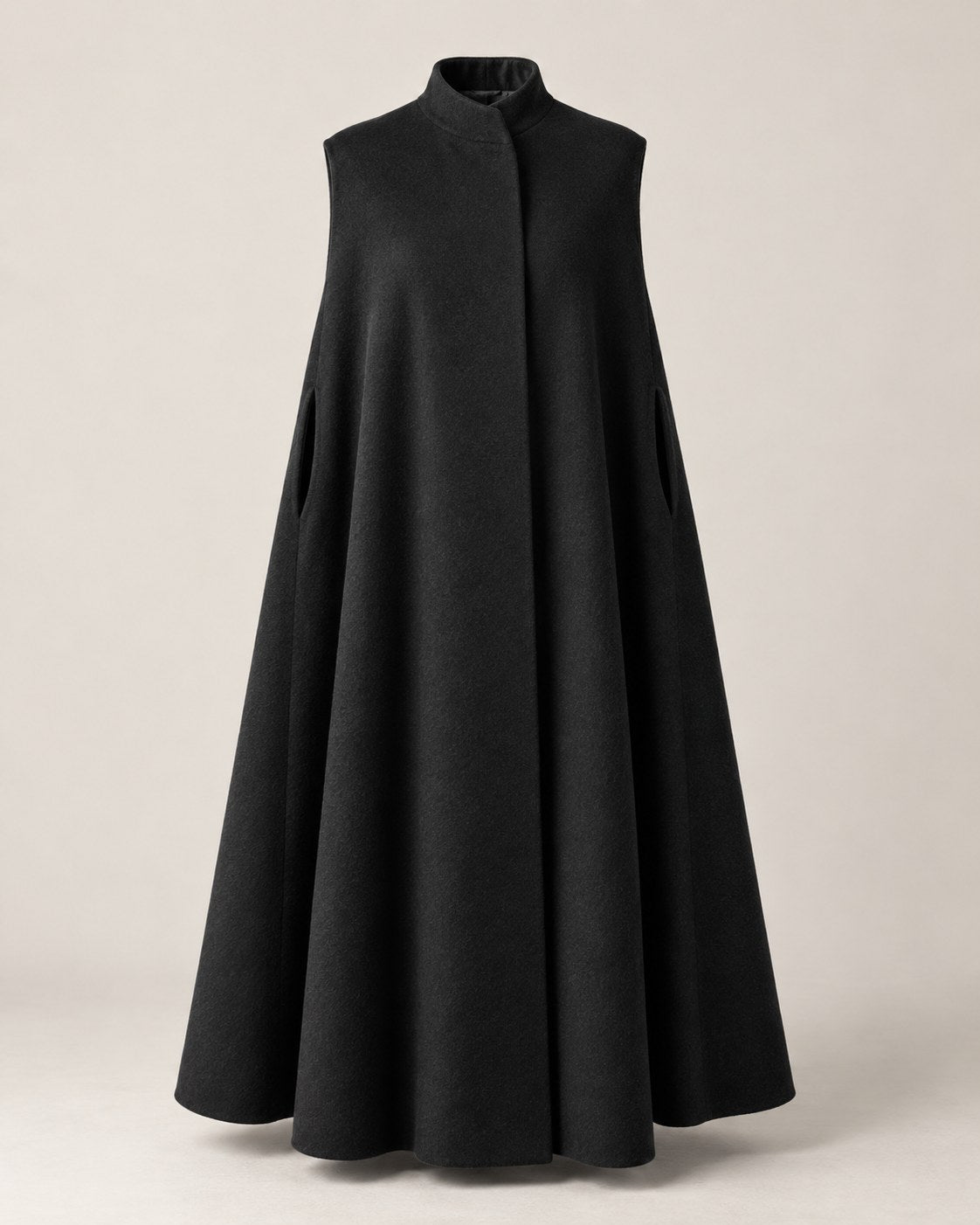 Generously cut cape in Black with a small stand collar and arm openings.